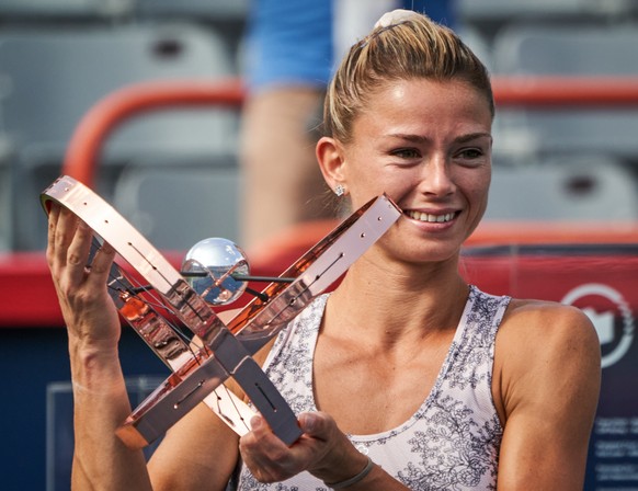 epa09415808 Camila Giorgi of Italy poses with the trophy after winning against Karolina Pliskova of Czech Republic in the final of the National Bank Open women's tennis tournament in Montreal, Canada, 15 August 2021.  EPA/ANDRE PICHETTE