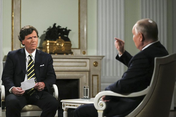 In this photo released by Sputnik news agency on Friday, Feb. 9, 2024, Russian President Vladimir Putin, right, gestures as he speaks during an interview with former Fox News host Tucker Carlson at th ...