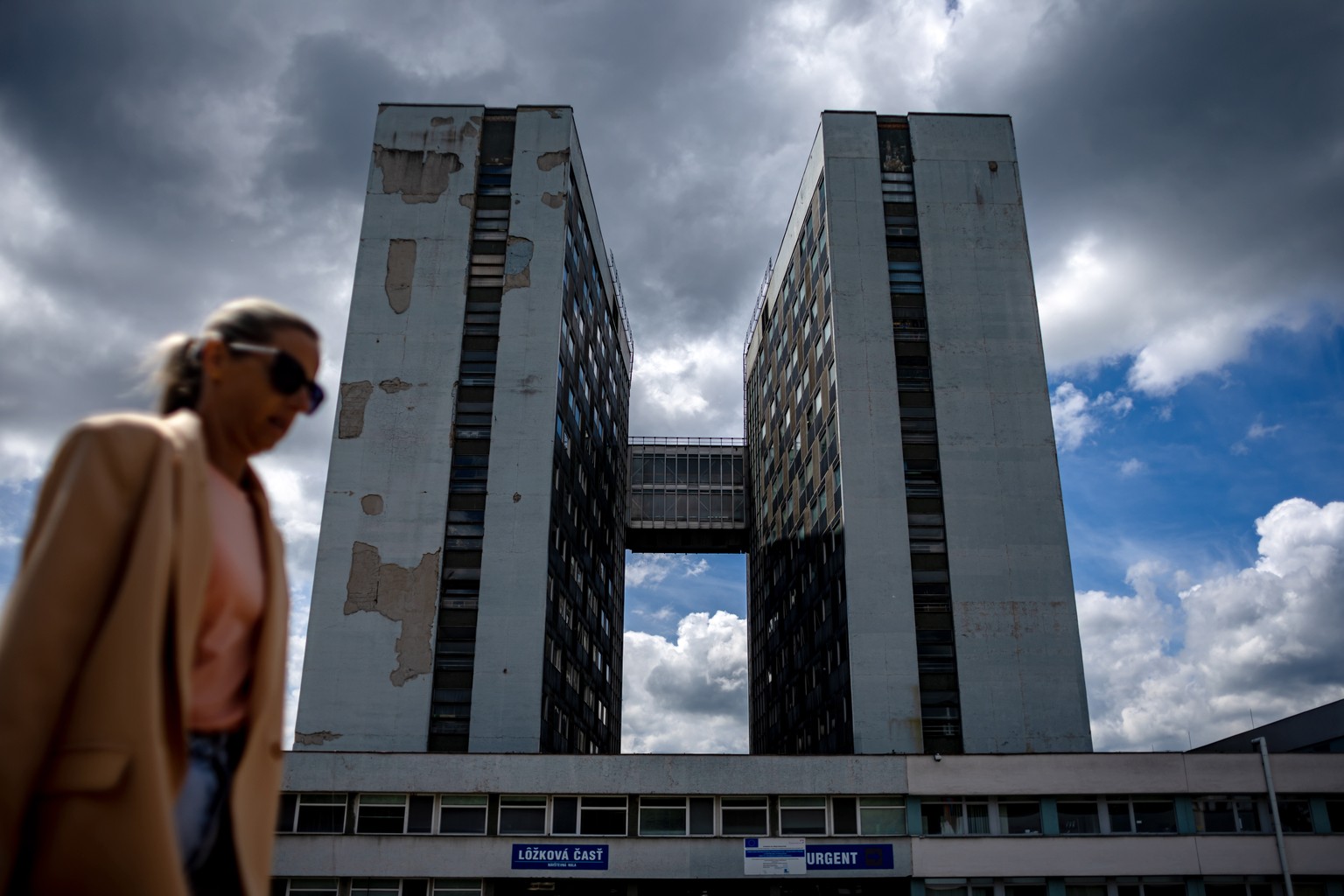 epa11344230 A woman walks outside the F. D. Roosevelt University Hospital, where Slovak Prime Minister Robert Fico is being treated after being shot at one day earl;ier, in Banska Bystrica, Slovakia,  ...