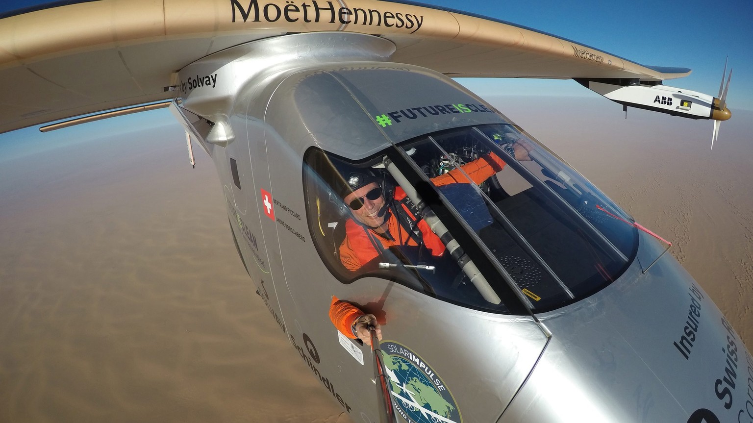 epa05441387 A handout picture made available by Solar Impulse on 26 July 2016, shows Swiss pilot Bertrand Piccard taking a selfie during the last leg of the first round-the-world solar flight with Sol ...