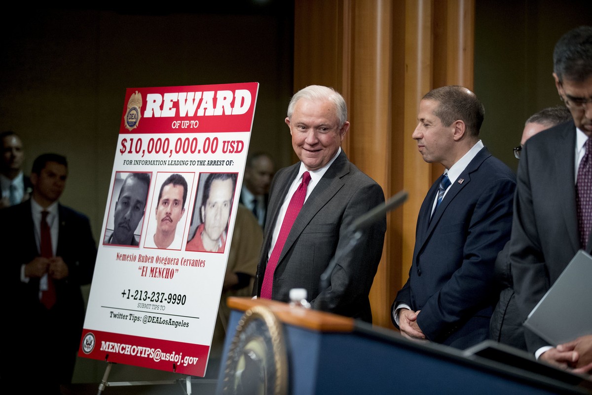 Attorney General Jeff Sessions, center, accompanied by officials from the State Department, Treasury Department, Internal Revenue Service and Immigration and Customs Enforcement, arrives to speak at a ...