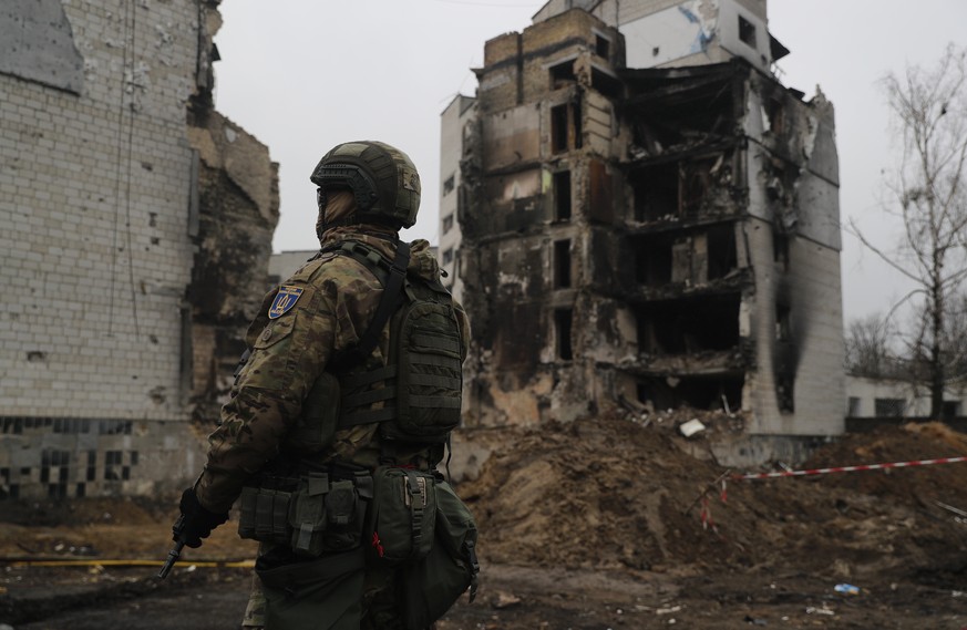 epa09900370 A Ukrainian soldier stands guard as Spanish Prime Minister, Pedro Sanchez (unseen), and Danish counterpart, Mette Frederiksen (unseen), visit the city of Borodyanka, in Ukraine, 21 April 2 ...