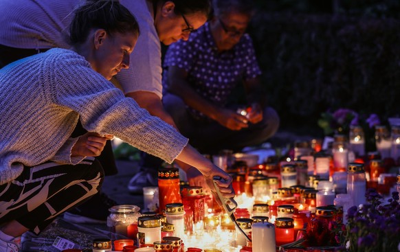 epa11565953 People light candles near the crime scene in Solingen, Germany, 26 August 2024. A man stabbed passers-by at random with a knife during the city festival in Solingen on 23 August evening. T ...