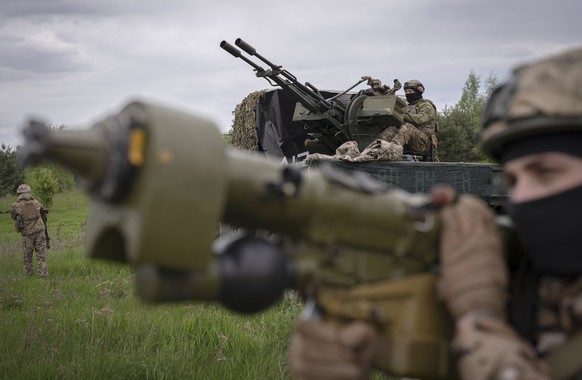 Members of a Ukrainian air-defense unit demonstrate their work near Kyiv on Monday, May 8, 2023. From camouflaged positions, the units dart out by truck into the farm fields around the capital, ready  ...