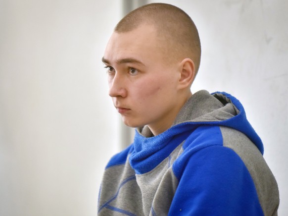 epa09957498 Russian serviceman Vadim Shishimarin sits in the dock on the second day of his war crimes trial in the Solomyansky district court in Kyiv, Ukraine, 19 May 2022. Shishimarin on the first da ...