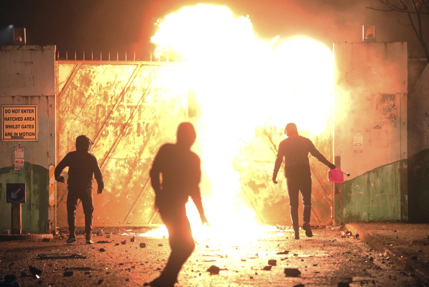 Nationalists and Loyalists clash with one another at the peace wall on Lanark Way in West Belfast, Northern Ireland, Wednesday, April 7, 2021. The police had to close roads into the nearby Protestant  ...