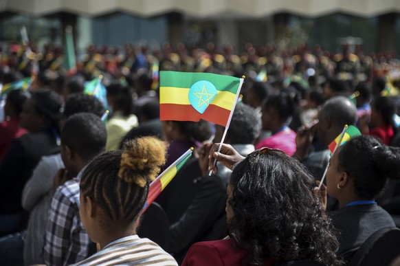 A member of the audience holds a national flag at a ceremony to remember those soldiers who died on the first day of the Tigray conflict, outside the city administration office in Addis Ababa, Ethiopi ...