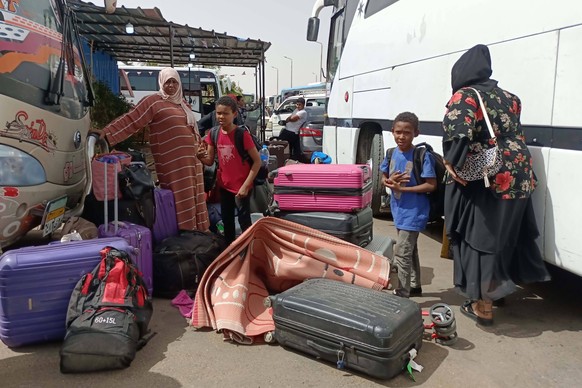 230425 -- ASWAN EGYPT, April 25, 2023 -- People fleeing Sudan arrive at a bus station in Aswan, Egypt, on April 25, 2023.  Many people entered Egypt through the border crossing between Egypt ...