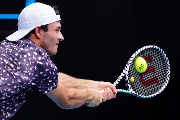 epa08149627 Tommy Paul of the USA in action during his second round match against Grigor Dimitrov of Bulgaria on day three of the Australian Open tennis tournament at Melbourne Park in Melbourne, Aust ...