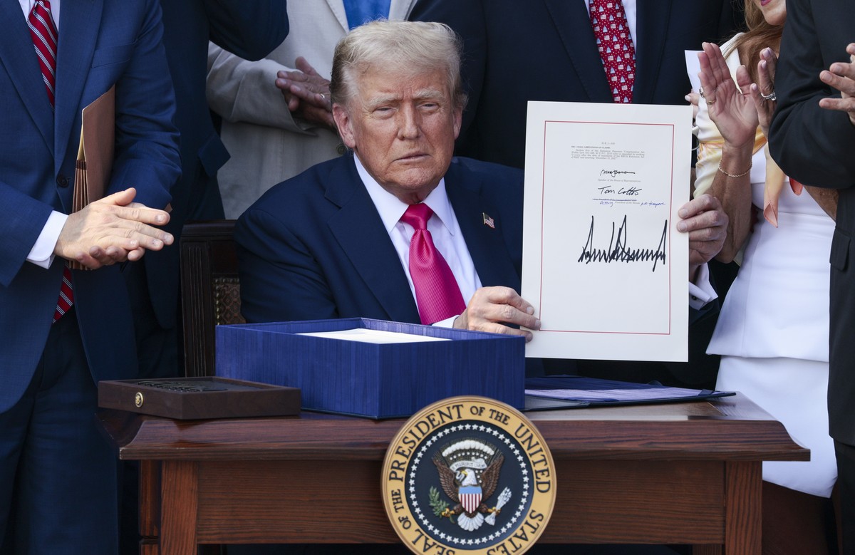 epa12216701 US President Donald J. Trump, with lawmakers, signs his 'Big Beautiful Bill' into law during the Independence Day Military Family Picnic on the South Lawn of the White House in W ...