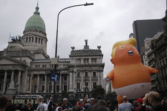 Opponents to the G20 summit carry a giant inflatable doll depicting U.S. President Donald Trump wearing a diaper in front of Congress in Buenos Aires, Argentina, Thursday, Nov. 29, 2018. Leaders from  ...