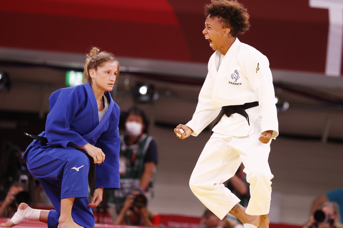 epa09363863 Amandine Buchard of France (white) reacts after her win against Fabienne Kocher of Switzerland (blue) during their bout in the Women's -52kg Semifinal of Table A Judo events of the To ...