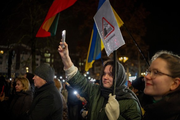 People take part in a protest against politicians' desire to restrict media freedom, at Independence Square at the Parliament Palace in Vilnius, Lithuania, Wednesday, Dec. 17, 2025. (AP Photo/Min ...