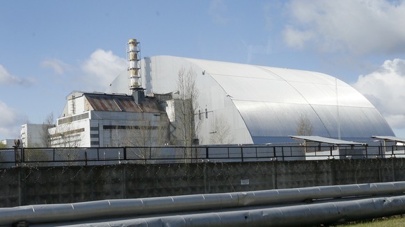 FILE - A shelter construction covers the exploded reactor at the Chernobyl nuclear plant, in Chernobyl, Ukraine, on April 27, 2021. Among the most worrying developments on an already shocking day, as  ...