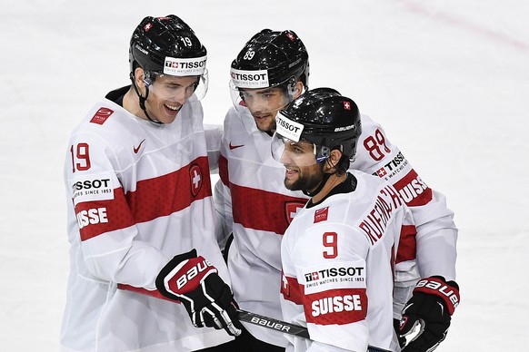 Switzerland’s Reto Schaeppi, Cody Almond, and Thomas Ruefenacht, from left, celebrate the score to 2:0 during their Ice Hockey World Championship group B preliminary round match between Switzerland an ...