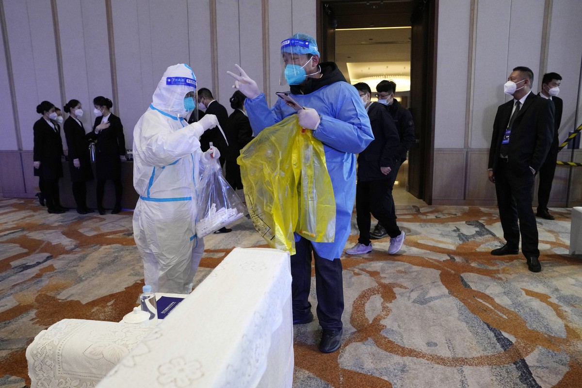Health workers collect swab samples from the environment before a session for the Financial Street Forum 2022 held in Beijing, Monday, Nov. 21, 2022. China is the only major country in the world still ...