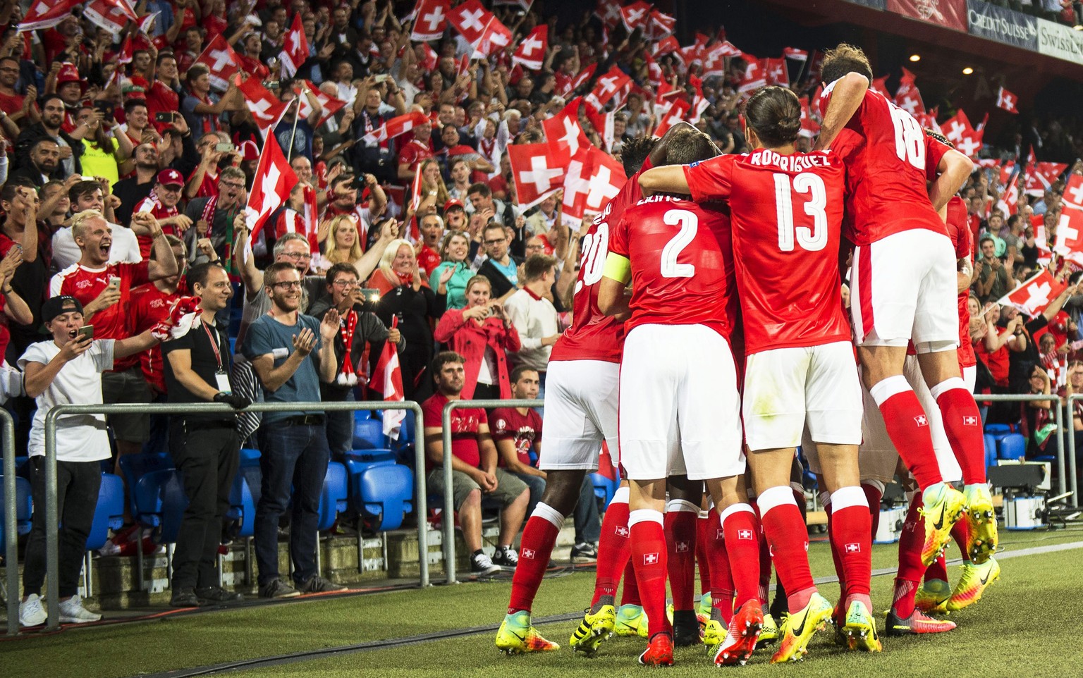 epa05527849 Swiss players celebrate their opening goal during the FIFA World Cup 2018 group B qualifying soccer match between Switzerland and Portugal at the St. Jakob-Park stadium in Basel, Switzerla ...