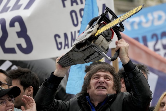 Presidential hopeful of the Liberty Advances coalition Javier Milei brandishes a chainsaw during a campaign event in La Plata, Argentina, Tuesday, Sept. 12, 2023. Milei has used the chainsaw throughou ...