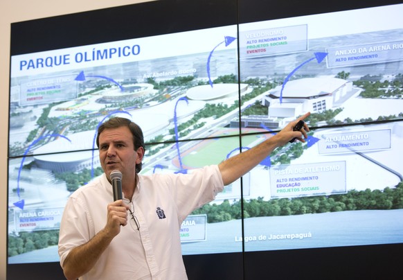 Rio de Janeiro Mayor Eduardo Paes points to a screen showing Olympic Park, at the Olympic City Museum in Rio de Janeiro, Brazil, Tuesday, July 5, 2016. The inauguration of the museum, which includes a ...