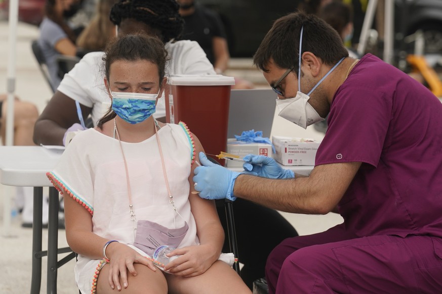 Francesca Anacleto, 12, receives her first Pfizer COVID-19 vaccine shot from nurse Jorge Tase, Wednesday, Aug. 4, 2021, in Miami Beach, Fla. On Tuesday, the CDC added more than 50,000 new COVID-19 cas ...