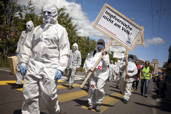 epa09219820 People demonstrate during the &#039;Stiller Protest&#039; association march to protest against anti-COVID-19 measures, in Neuchatel, Switzerland, May 22, 2021. As Switzerland is gradually  ...