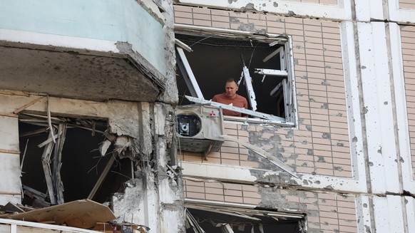 epa12966850 A man inspects a damaged apartment building following a drone attack outside Moscow, Russia, 17 May 2026. According to Russian authorities, at least three people were killed in overnight d ...