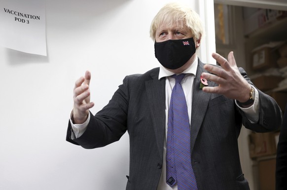 Britain&#039;s Prime Minister Boris Johnson visits a COVID-19 vaccination centre in a pharmacy in Sidcup, south east England, Friday Nov. 12, 2021, during a visit to Old Bexley and Sidcup. (Henry Nich ...