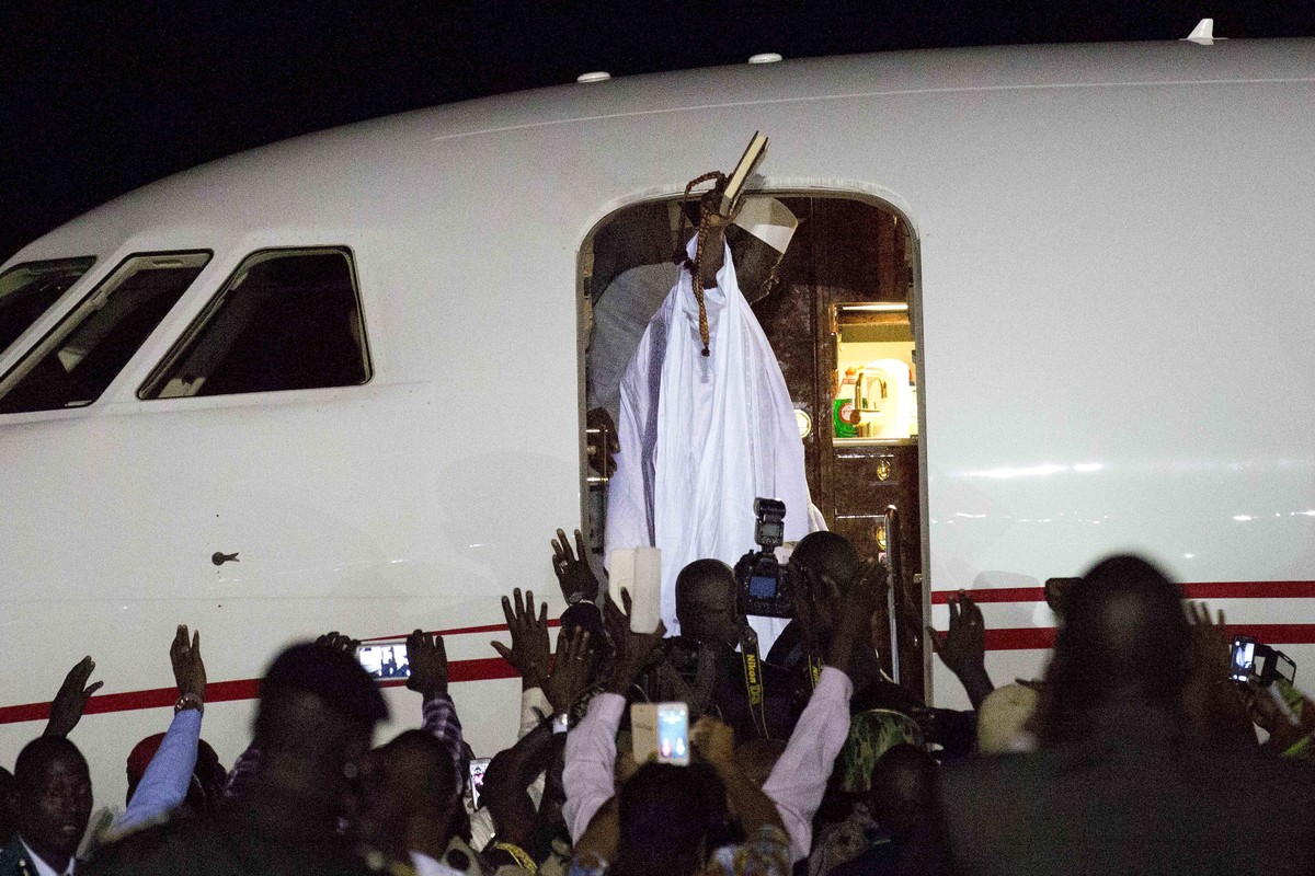 Gambia's defeated leader Yahya Jammeh waves to supporters as he departs from Banjul airport Saturday Jan. 21, 2017. Jammeh announced early Saturday he has decided to relinquish power, after hours ...
