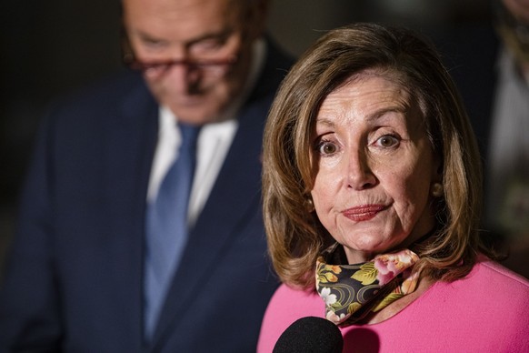 epa08590584 Speaker of the House Nancy Pelosi (D-CA) (R) makes a statement to reporters alongside Senate Minority Leader Chuck Schumer (D-NY) (L) following continued negotiations in the US Capitol in  ...