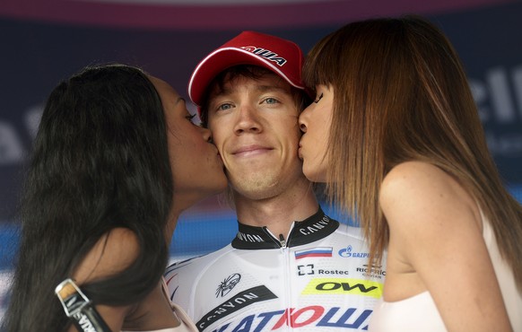 Team Katusha rider Ilnur Zakarin of Russia receives kisses as he celebrates on the podium after winning the 153 km (95 miles) eleven stage of the 98th Giro d&#039;Italia (Tour of Italy) cycling race f ...