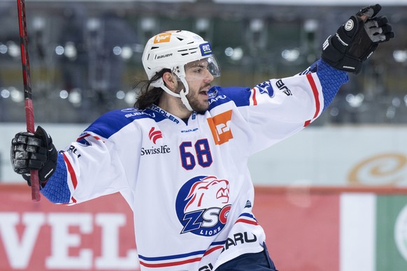 ZUM PREMIUM-TEXT UEBER DEN EISHOCKEY-SPIELER WILLY RIEDI STELLEN WIR IHNEN FOLGENDES BILDMATERIAL ZUR VERFUEGUNG --- Lions Willy Riedi jubelt waehrend dem Meisterschaftsspiel der National League zwisc ...