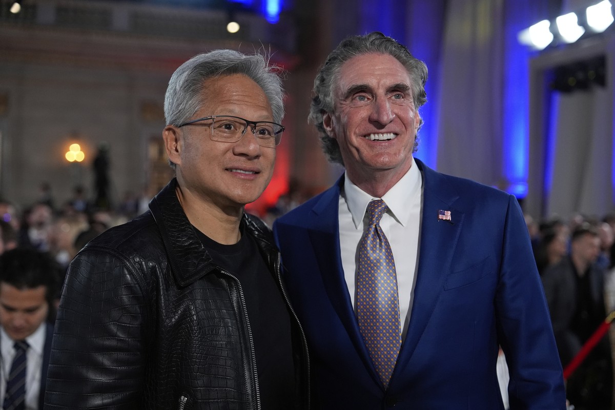 Nvidia CEO Jensen Huang poses for a photo with Interior Secretary Doug Burgum before President Donald Trump speaks during an AI summit at the Andrew W. Mellon Auditorium, Wednesday, July 23, 2025, in  ...