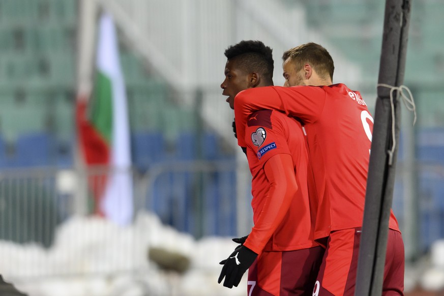 Switzerland&#039;s forward Breel Embolo, left, celebrates after scoring the first goal (1-0) with Switzerland&#039;s forward Haris Seferovic, right, during the closed door FIFA World Cup Qatar 2022 qu ...