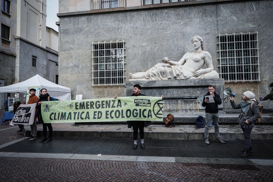 epa10347787 'Extinction Rebellion' activists carry banners at a protest urging to 'manage the climate crisis, halt the loss of biodiversity and minimize the risk of extinction...