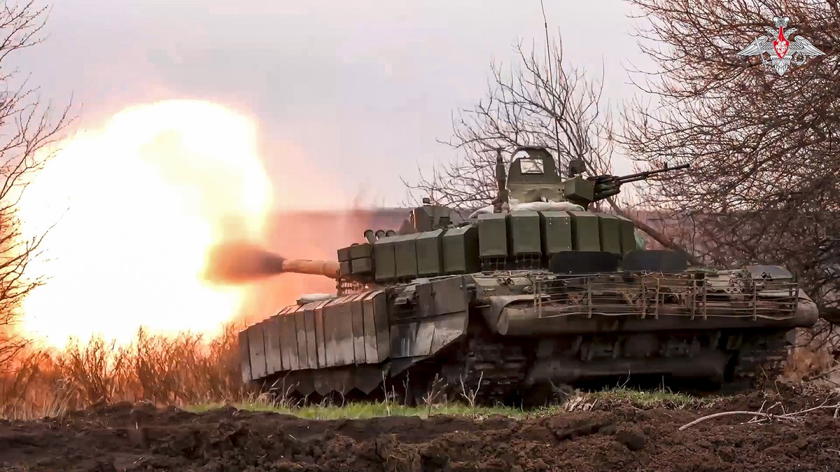 In this photo released by the Russian Defense Ministry Press Service on Tuesday, March 19, 2024, A Russian tank fires its cannon at Ukrainian troops from a position near the border with Ukraine in the ...