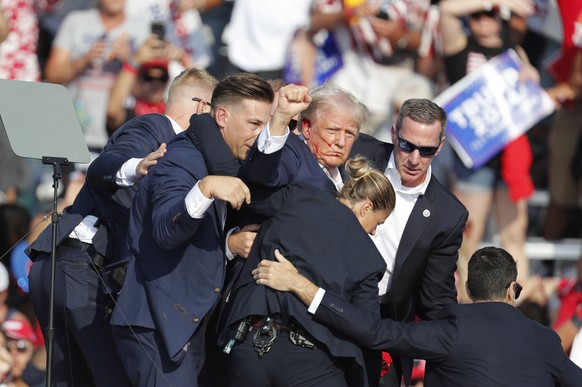 epaselect epa11476746 Former US President Donald Trump is rushed off stage by secret service after being shot at during a campaign rally at the Butler Farm Show Inc. in Butler, Pennsylvania, USA, 13 J ...