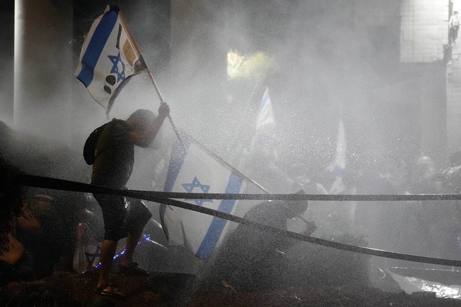 Police uses a water canon against demonstrators during a protest against plans by Netanyahu&#039;s government to overhaul the judicial system, in Tel Aviv, Monday, July 24, 2023. Israeli lawmakers on  ...