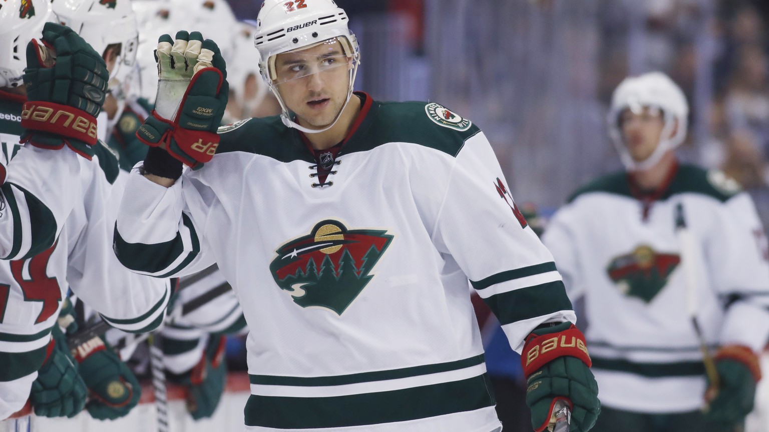 Minnesota Wild right wing Nino Niederreiter, of the Czech Republic, is congratulated as he passes the team box after scoring against the Colorado Avalanche during the third period of an NHL hockey gam ...