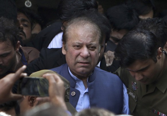 FILE - Former Pakistani Prime Minister Nawaz Sharif leaves a court in Lahore, Pakistan, on Oct. 8, 2018. Sharif is claiming that the country?s former powerful military and spy chiefs orchestrated his  ...