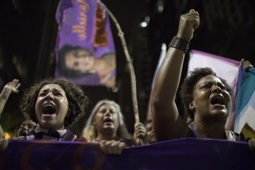 People shout slogans during a protest against the murder of councilwoman Marielle Franco in Rio de Janeiro, Brazil, Friday, March 16, 2018. Franco was slain Wednesday night while returning from an eve ...