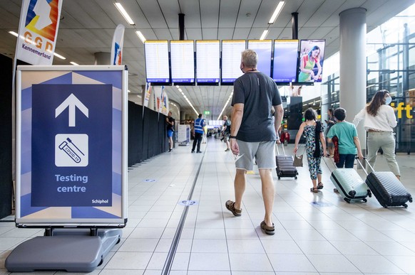 epa08600995 Travelers at the test centre at Schipholm Netherlands, 13 August 2020. Arriving travelers from risk areas are immediately referred by the GGD to the test centre when they get off the plane ...