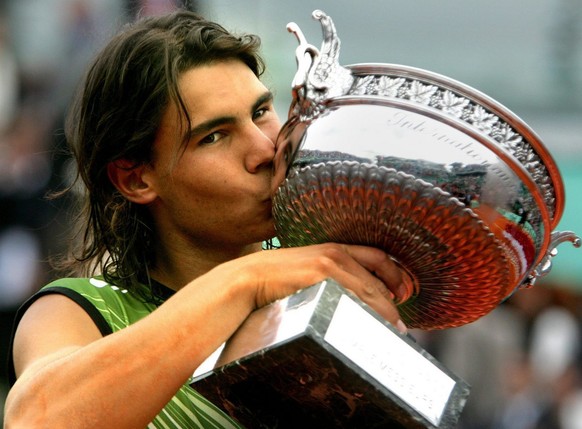 Spain&#039;s Rafael Nadal kisses the trophy after winning the Men&#039;s Final against Mariano Puerta of Argentina at the French Open in Roland Garros, Paris, Sunday 05 June 2005. Nadal won 6-7, 6-3,  ...
