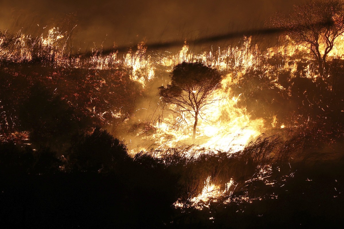 Fire burns near the towns of Alcamo and Partinico, in western Sicily, Italy, late Sunday night, Aug. 27, 2023. The intensity of the fires and the density of the smoke forced authorities to close the n ...