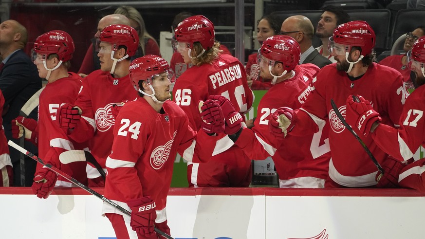 Detroit Red Wings center Pius Suter (24) celebrates his goal against the Pittsburgh Penguins in the first period of an NHL preseason hockey game Thursday, Oct. 7, 2021, in Detroit. (AP Photo/Paul Sanc ...