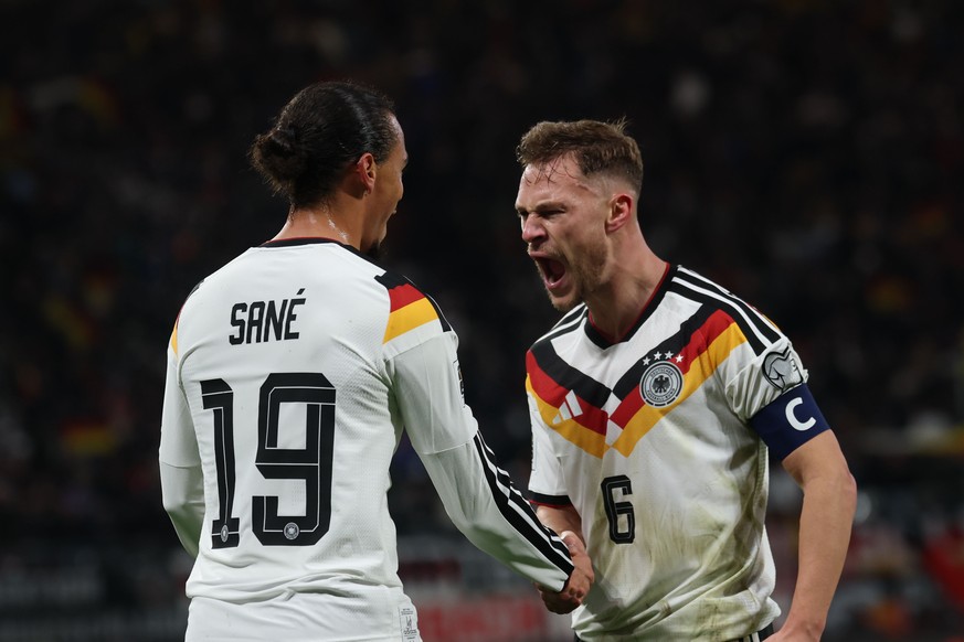 epa12532383 Leroy Sane of Germany (L) celebrates with teammate Joshua Kimmich of Germany (R) after scoring the 3-0 during the FIFA World Cup 26 UEFA qualifier between Germany and Slovakia in Leipzig,  ...