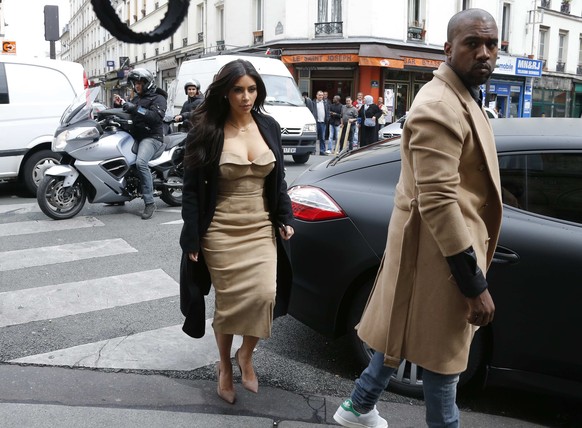 TV personality Kim Kardashian and rapper Kanye West arrive at a fashion designer workshop in Paris May 21, 2014. U.S. television personality Kim Kardashian and rapper Kanye West will celebrate their w ...