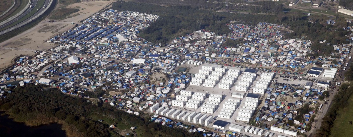 An aerial view shows white containters, tents and makeshift shelters on the eve of the evacuation and dismantlement of the camp called the "Jungle" in Calais, France, October 23, 2016. REUTE ...