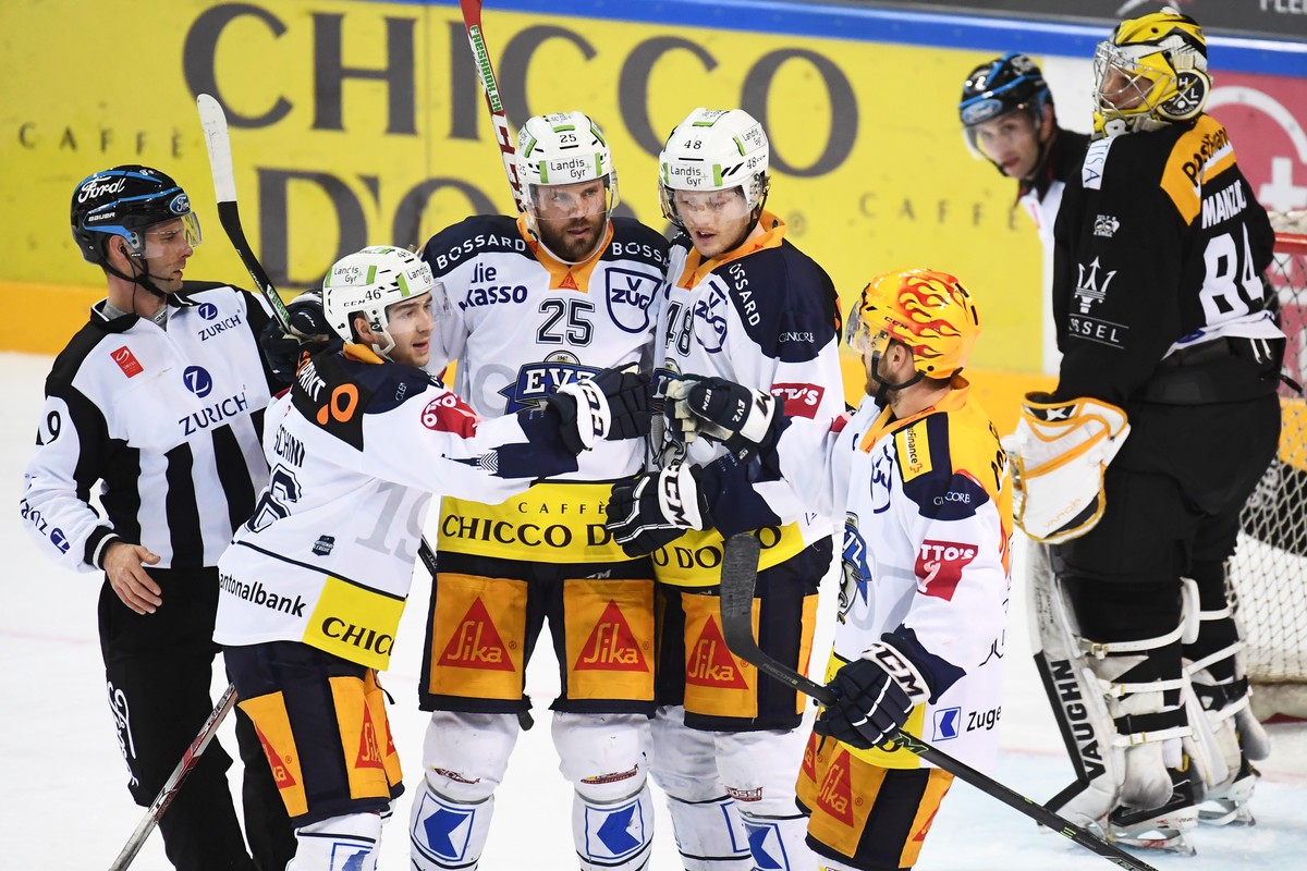 Zug's player Lino Martschini, Zug's player Viktor Stalberg, Zug's player Carl Klingberg and Zug's player Garrett Roe celebrate 2-4 goal during the preliminary round game of Nationa ...