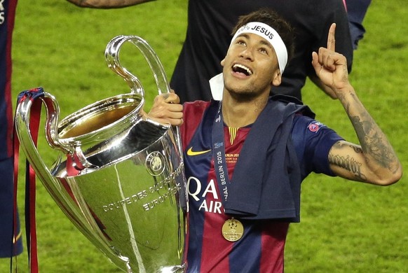 FILE - In this Saturday, June 6, 2015 file photo, Barcelona&#039;s Neymar celebrates with the trophy after the Champions League final soccer match between Juventus Turin and FC Barcelona at the Olympi ...
