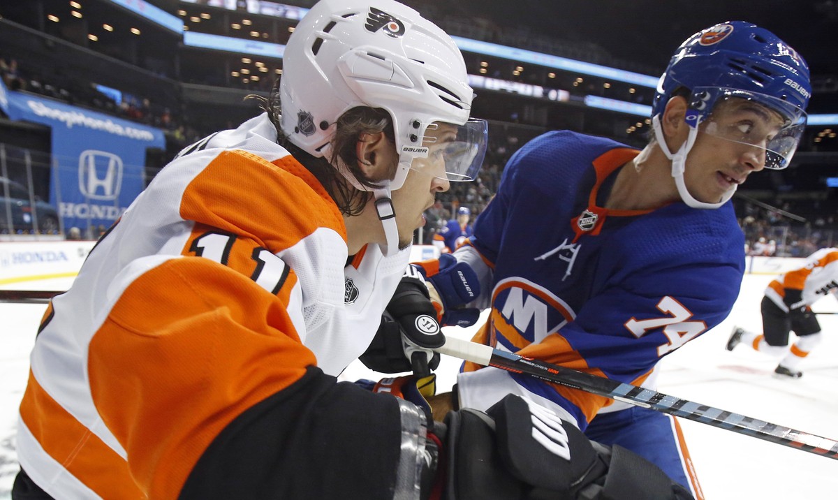 Philadelphia Flyers' Travis Konecny (11) battles with New York Islanders' Luca Sbisa in the third period of a preseason NHL hockey game on Tuesday, Sept. 18, 2018, in New York. (AP Photo/Ada ...